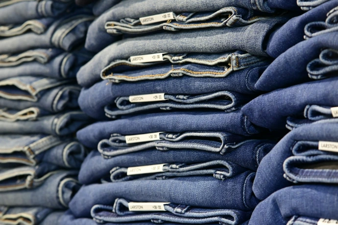 A stack of neatly folded blue jeans.